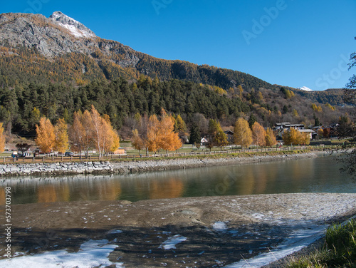 Brusson lake in autumn. Ayas valley, Italy.