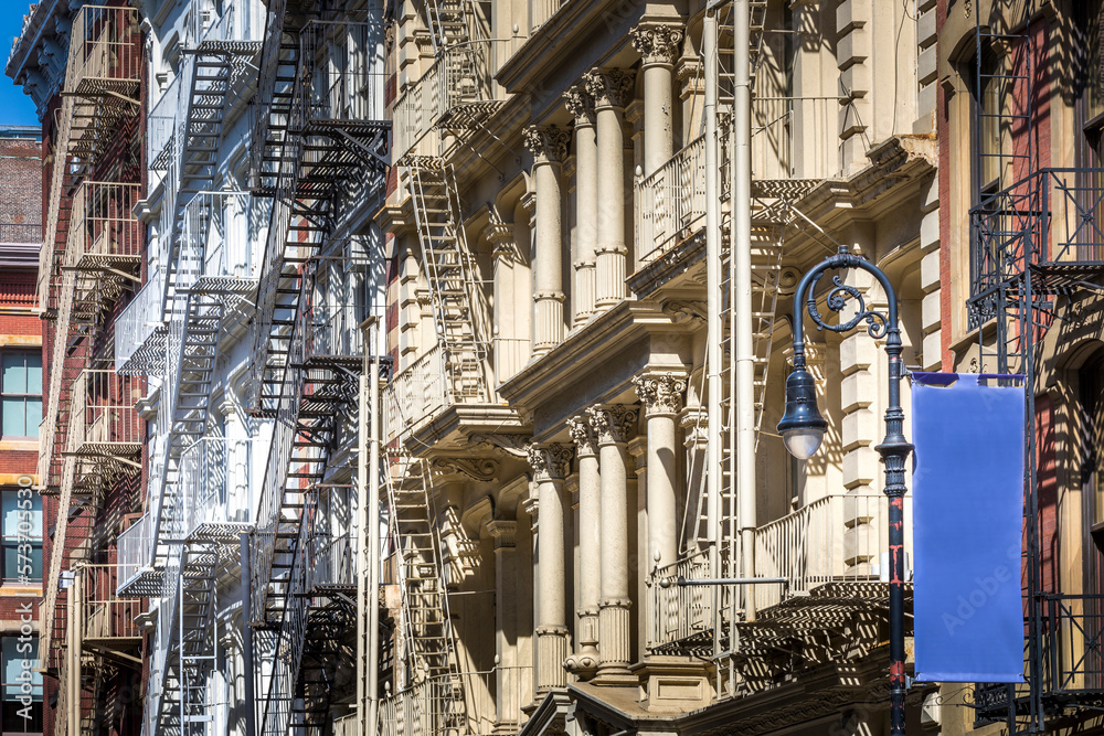 New York, USA - April 23, 2022: Typical New York City building with fire escape ladders