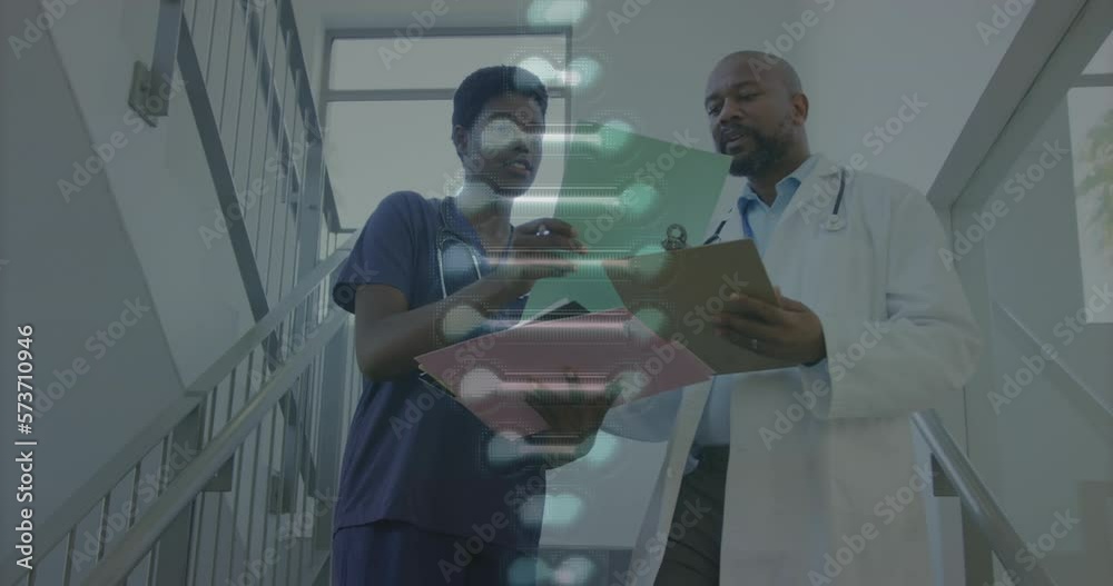 Animation of dna strand and data over african american female and male doctor discussing notes Animation of dna strand and data over african american female and male doctor discussing notes