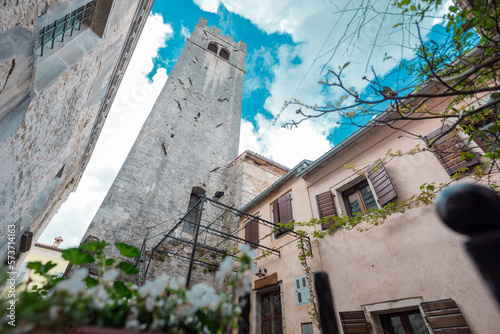 View of a church and bell tower in the medieval village of Motovun in Croatian Istria. Frog view overlooking the square. photo