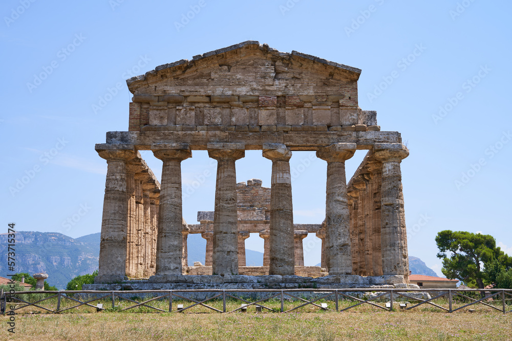 Front view on the Athena Temple from the Unesco World Heritage Site in Paestum. The facility is located in the Campania region of Italy. Ancient Greek culture in southern Italy. Front view on the Athena Temple from the Unesco World Heritage Site in Paestum. The facility is located in the Campania region of Italy. Ancient Greek culture in southern Italy.