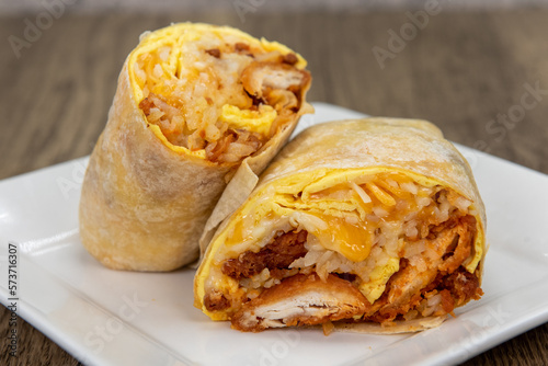 Egg and crispy potato breakfast burrito filled with rice, cheese, and salsa for a very large appetite © motionshooter