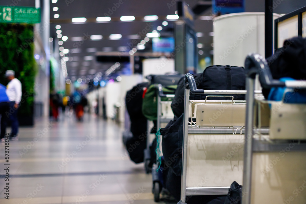Macro closeup of full luggage carts in a row at El Dorado airport, Bogota, Colombia Macro closeup of full luggage carts in a row at El Dorado airport, Bogota, Colombia