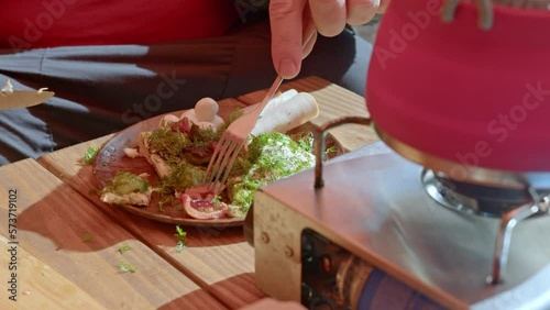 A man cuts a salad. Travel kitchen. Lunch in nature