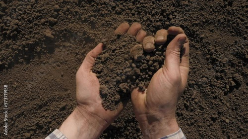 Handful of dirt hands holding soil hand field agriculture farmer hands full of soil organic earth ground. Fertile soil preparation field agriculture farming industry agricultural field. Fertile ground