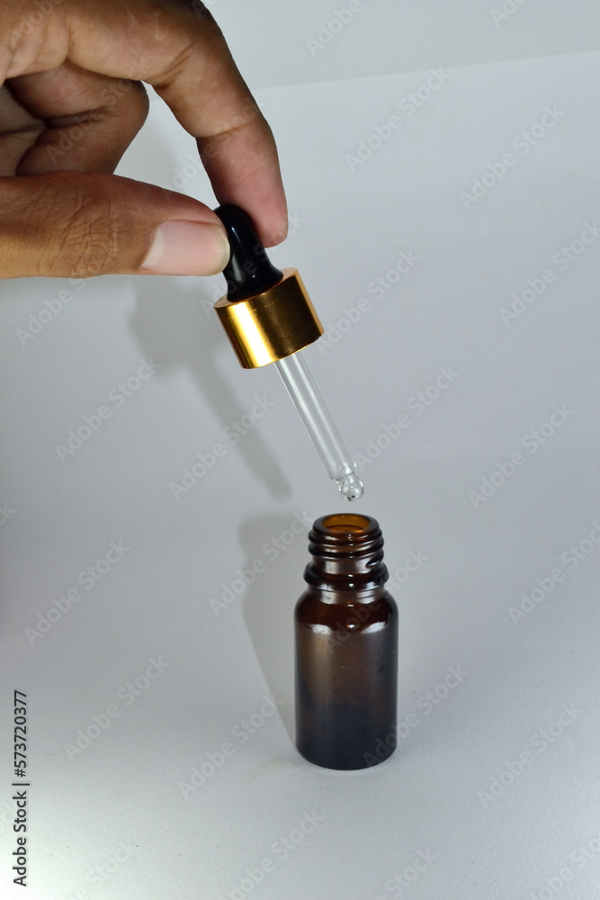 Dark brown dropper bottle with flowers on the side Dark brown dropper bottle with flowers on the side