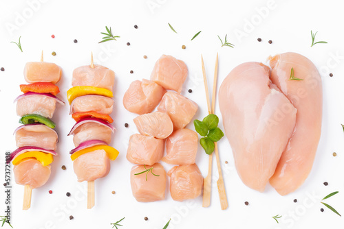 Uncooked meat skewer with peppers.Chicken Skewers breast fillet meat.Skewers with pieces of raw meat,red,yellow pepper.Raw chicken skewers with vegetables, peppers,onions,white background.Top view. photo