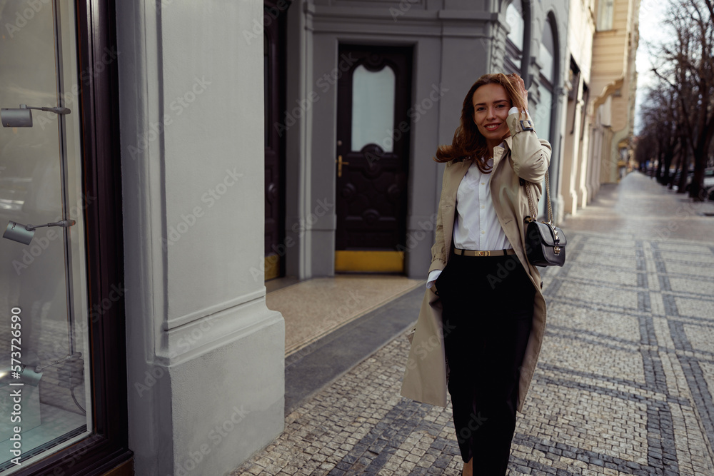 Smiling woman crossing the city street and looking at camera. High quality photo Smiling woman crossing the city street and looking at camera. High quality photo