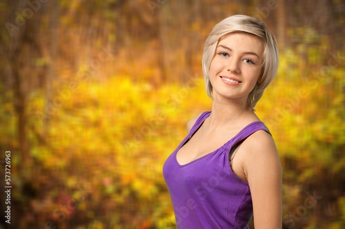 Smiling young woman posing in forest