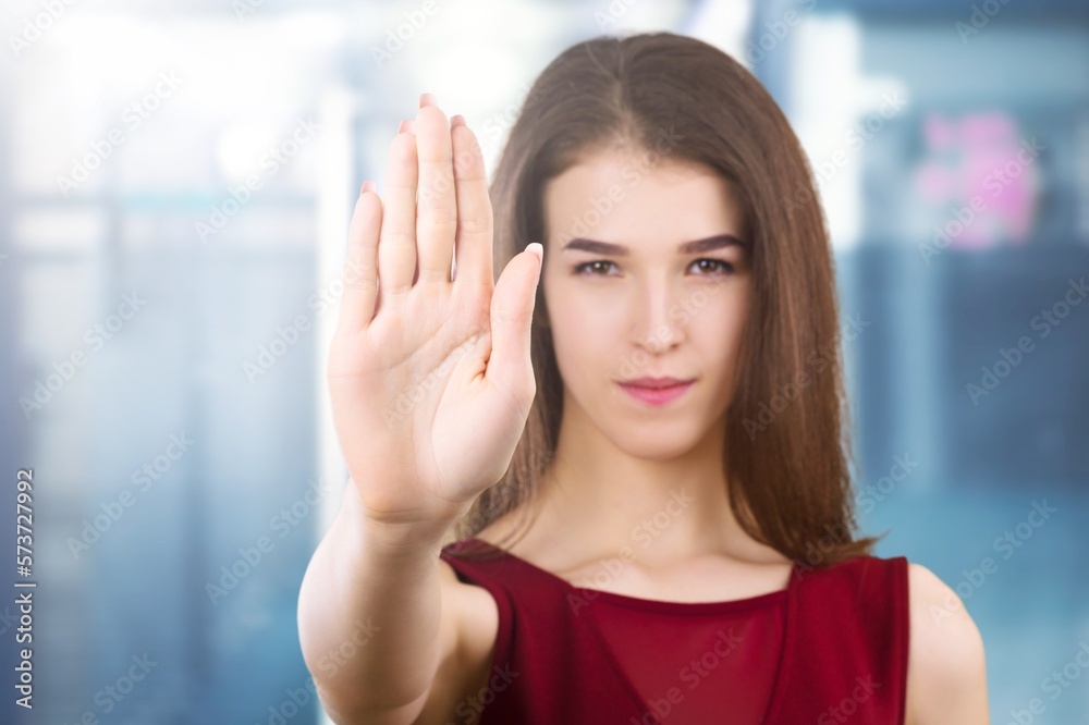 Young woman show stop sign with hand