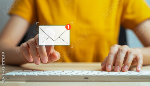 Hand type a message on the keyboard and hand touching on a digital screen of new email notifications, messages to deliver.
