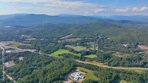 Plymouth State University and Pemigewasset River aerial view with White Mountain National Forest at the background in summer in historic town center of Plymouth, New Hampshire NH, USA.  photo