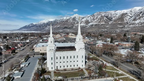 Aerial Brigham City Utah LDS Temple pull. The Church of Jesus Christ of Latter-day Saints, LDS or Mormon Church. Spiritual sacred church. Urban neighborhood in mountain valley. Winter snow. photo