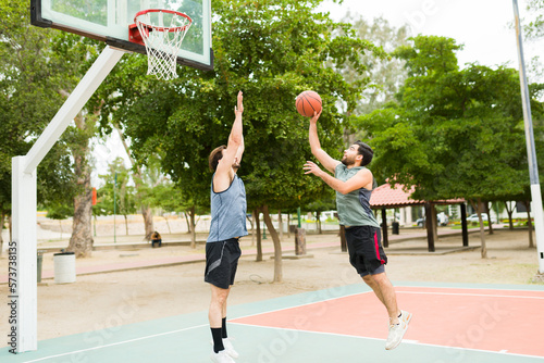 Full length of friends having fun playing basketball © AntonioDiaz
