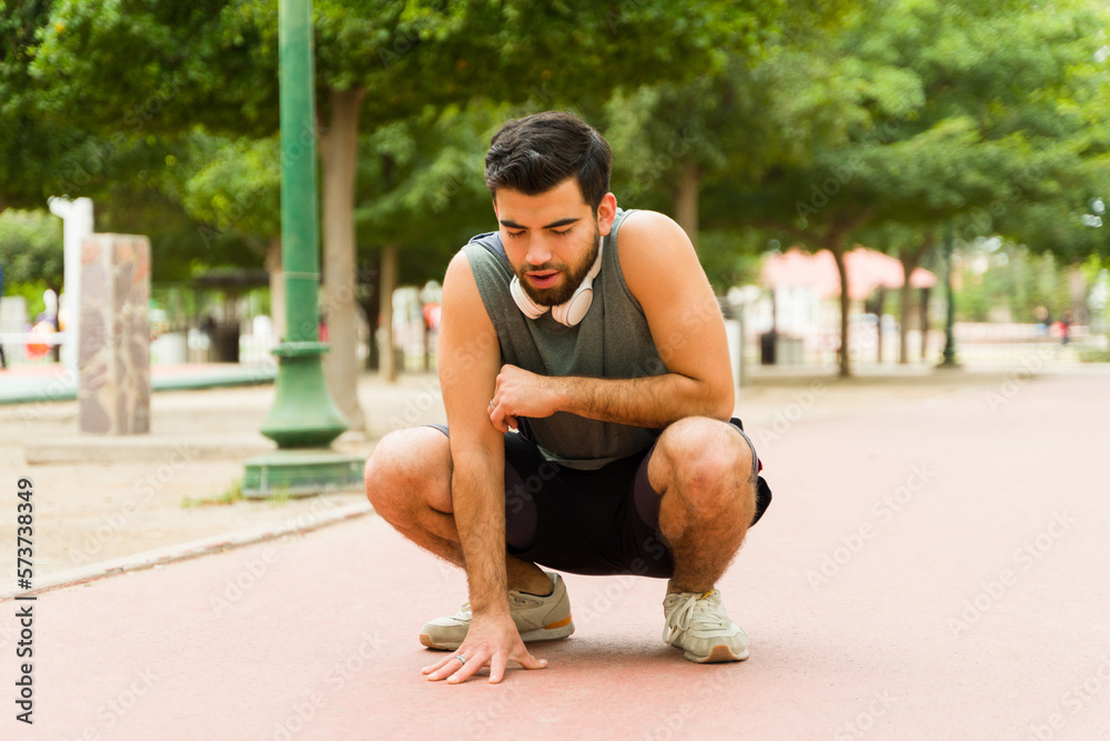 Fit man taking a break after running Fit man taking a break after running