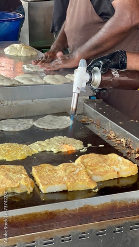 person working on a barbecue
