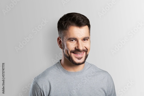 Happy young man posing on background