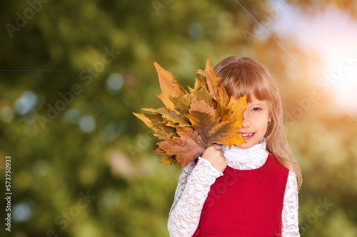 Happy small child hold autumn leaves