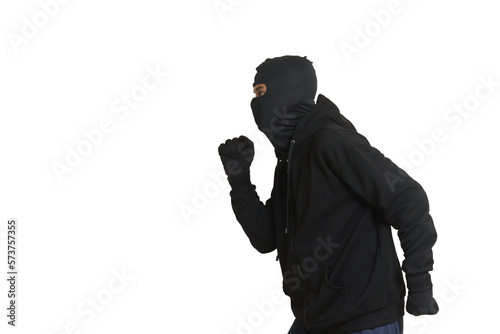 Side view portrait of a masked thief wearing black hoodie sneaking forward and walking slowly. Isolated image on white background