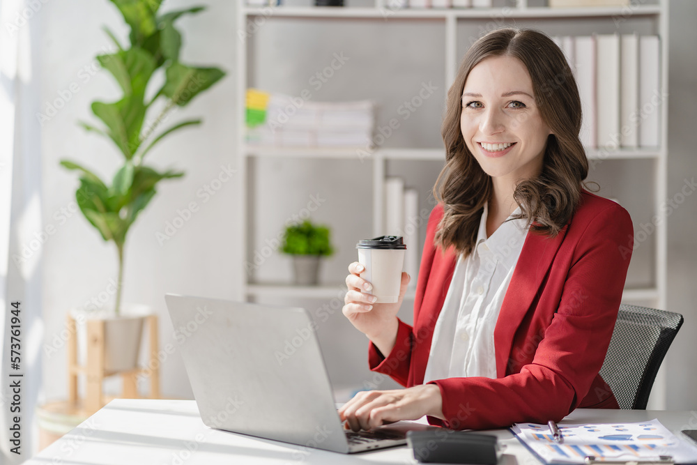 American businesswoman smiling confidently using laptop computer working on financial statistics presentation with graph document Female accountant analyzing data in office looking at camera
American businesswoman smiling confidently using laptop computer working on financial statistics presentation with graph document Female accountant analyzing data in office looking at camera