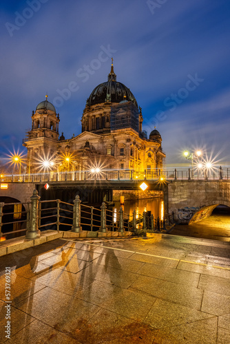 The imposing Berlin Cathedral at the banks of the river Spree at night