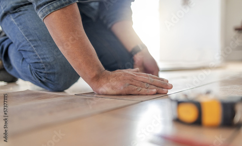 Construction worker hands, wood carpenter and home floor renovation of a builder. Working, woodwork and handcraft of a manufacturing, building and house maintenance development of an artisan