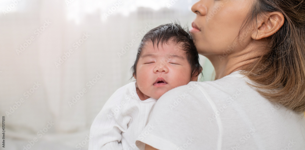 happy loving family. mother playing with her baby hugging in the bedroom , portrait of asian mother playing with newborn baby, health care family love together. asian girl lifestyle.. happy loving family. mother playing with her baby hugging in the bedroom , portrait of asian mother playing with newborn baby, health care family love together. asian girl lifestyle..