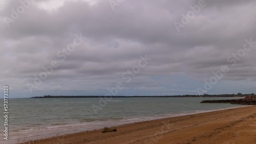 Timelapse of storm clouds as they move across a beach in Darwin, Northern Territory photo