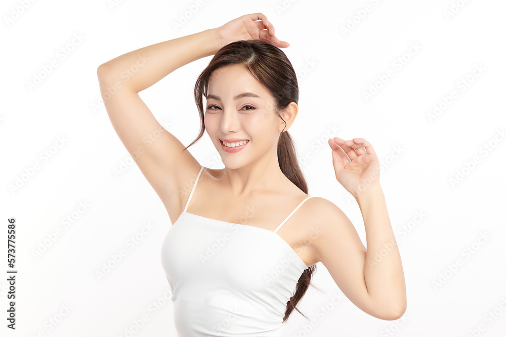 Beautiful Young Asian woman lifting hands up to show off clean and hygienic armpits or underarms on white background, Smooth armpit cleanliness and protection concept Beautiful Young Asian woman lifting hands up to show off clean and hygienic armpits or underarms on white background, Smooth armpit cleanliness and protection concept