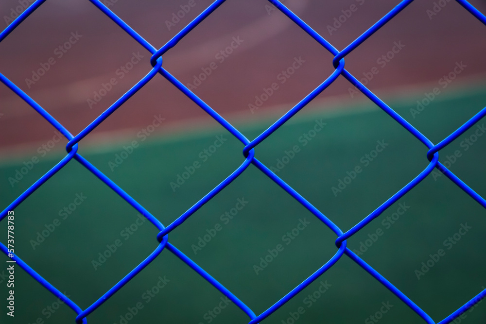 Fototapeta premium A blue mesh netting encloses the sports ground.