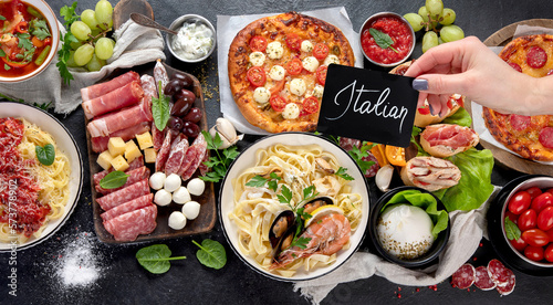 Italian food dishes on dark background.