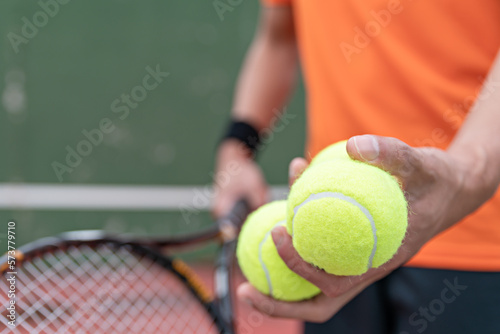 Man play tennis ball and tennis racquet, Professional tennis player, Sport and healthy lifestyle, concept of outdoor game sports, racket and green ball.
