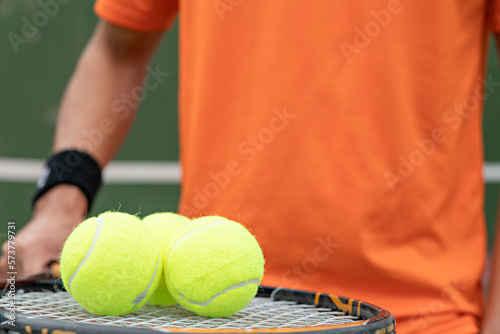 Man play tennis ball and tennis racquet, Professional tennis player, Sport and healthy lifestyle, concept of outdoor game sports, racket and green ball. © Meaw_stocker