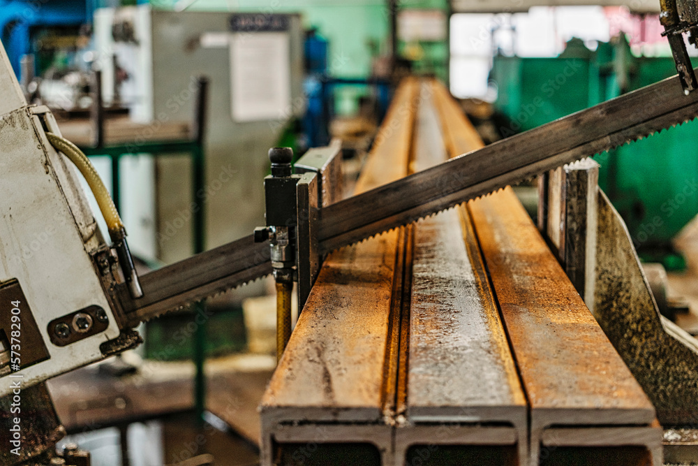 Machine for cutting metal profile. The saw cuts metal blanks into pieces. Industrial equipment for cutting and processing metal. Machine for cutting metal profile. The saw cuts metal blanks into pieces. Industrial equipment for cutting and processing metal.