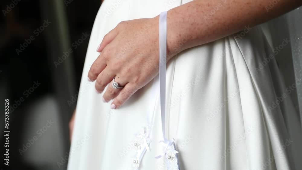 Close Up Of Bride's Lucky Horseshoe And Wedding Dress. Close Up Of Bride's Lucky Horseshoe And Wedding Dress.