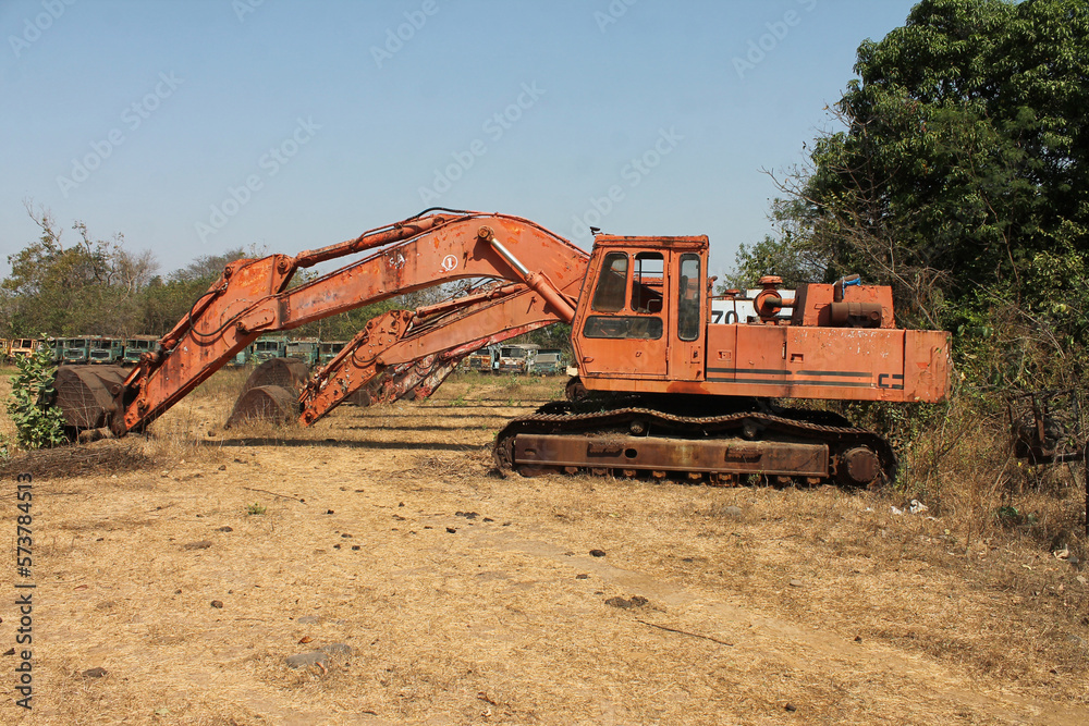 Fototapeta premium Parked rusty track excavators at workplace
