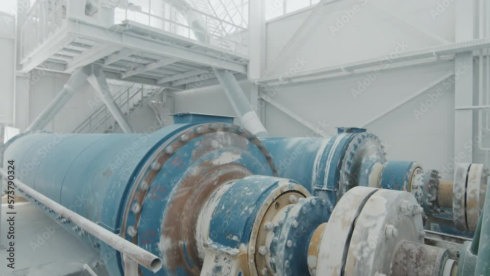No people shot of modern marble factory interior with blue ball mill machines grinding or blending stones No people shot of modern marble factory interior with blue ball mill machines grinding or blending stones