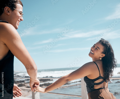 Couple of friends, laughing or holding hands by beach, ocean or sea in romance mock up, trust or summer holiday fun. Smile, happy man or bonding woman in travel location, funny game or freedom play