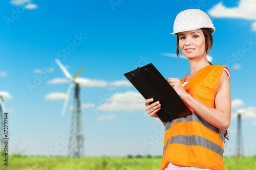 Young engineer working on windmills background. © BillionPhotos.com