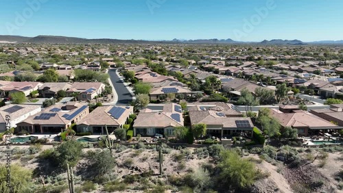 Wide aerial view of wealthy homes in the Arizona desert.