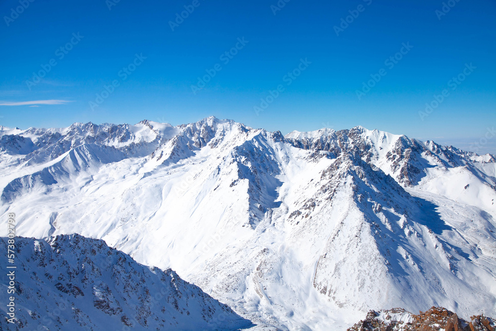 Obraz premium Beautiful landscape of winter mountains over clouds.