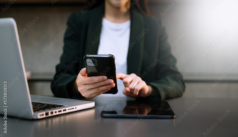 business documents on office desk with laptop and smart phone and graph business diagram and man working in morning light.