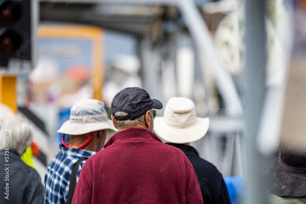 crowd of old people watching an event of boats outside in summer in australia