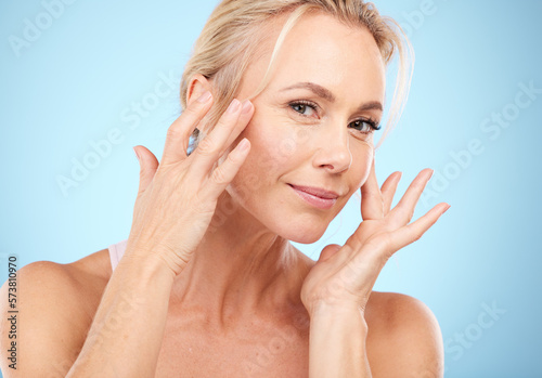 Woman  portrait and facial beauty to touch skincare  mockup and blue background for wellness cosmetics. Studio model  face and healthy aesthetic of laser dermatology  natural shine and salon results