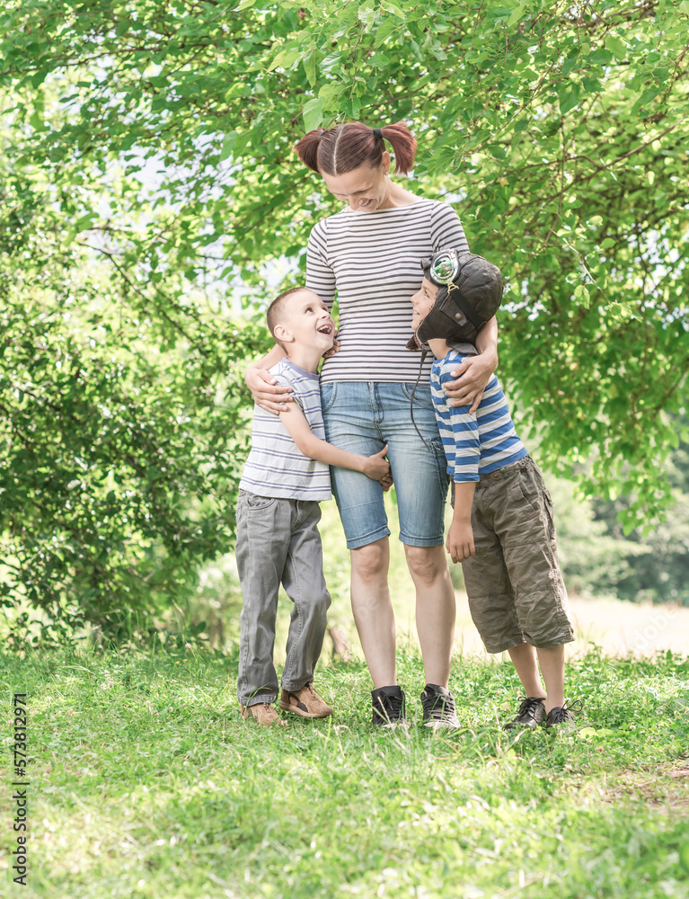 Fototapeta premium Mother and her child playing together. Woman and a boy are playing with a plane maker.Family holiday and togetherness.