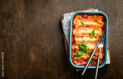 Cannelloni with meat, tomato sauce and cheese photo