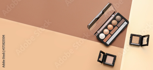 Fotografia Palette of makeup cosmetics on color background with space for text