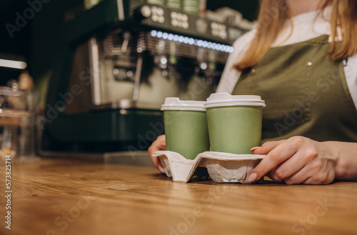 hot coffee cup and dessert paper bag waiting for customer on counter in modern cafe coffee shop