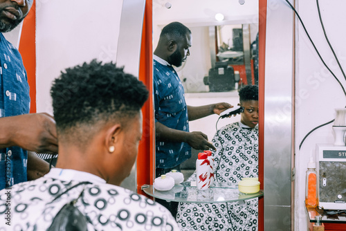 A young queer masculine woman getting a haircut