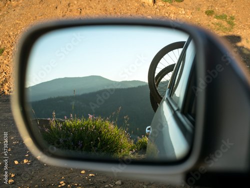 Bicycles on rack on back of car reflecting in side view mirror, McCall, Idaho, USA photo